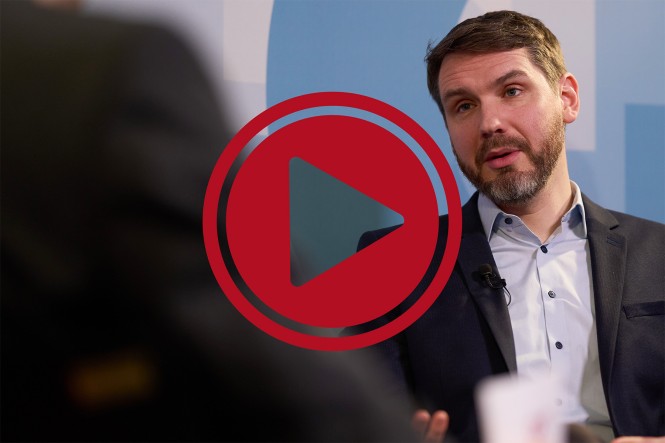 Portraitbild von Dr. Matthias Sonk. Davor ist ein roter Playbutton abgebildet.